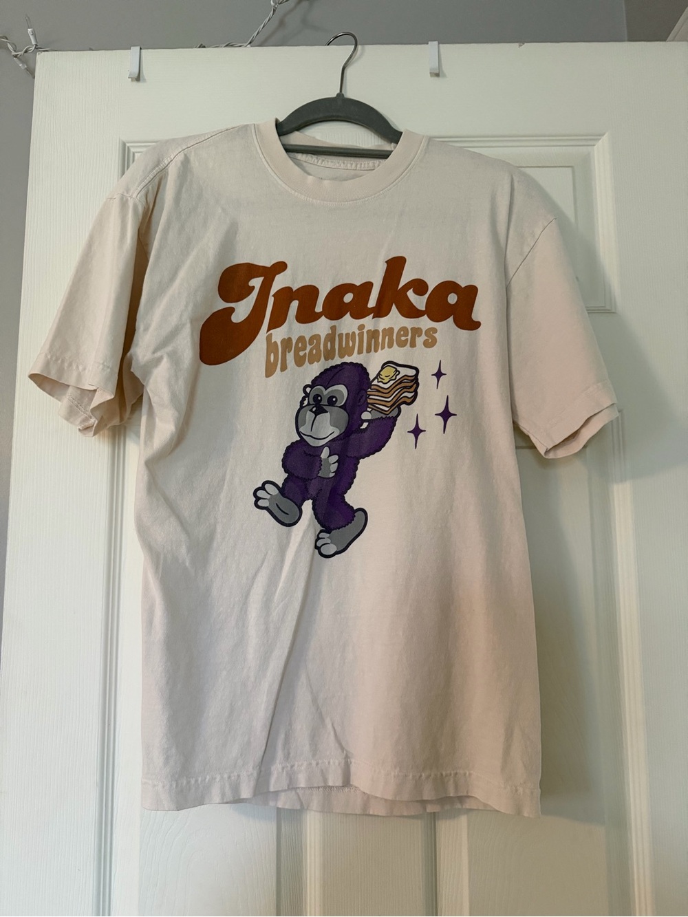 Inaka Breadwinners Graphic Tee - Cream with Brown & Purple Print